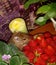 Still life. On the table in the bowl there is a bright red strawberry which is kept by small paws and is eaten by a hamster with