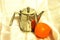 Still-life with teapot and orange.