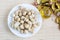 Still life with top view Macadamia nuts in the plate and bottle of oil