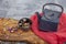 Still life with traditional asian herbal tea prepared in vintage cast iron teapot with organic dry herbs on rustic wooden table.