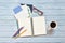 Still life, traveler memo concept, Top view image of open notebook with eyeglasses, postcard coffee cup and colorful pencil