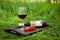 still life with tray, little red car, bottle, glass of wine outdoor