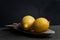 Still life with two lemons. Dark style