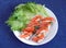 Still life with two small load of bread with cutted fresh tomatoes on cottage cheese and green salad leaves on round white plate o