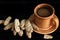 Still life of unusually tasty salt dough crackers with bran and caraway seeds and a cup of coffee