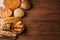 Still life with a varied assortment of bread on a wooden background with copy space