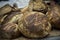 Still life of various delicious homemade breads on a wooden surface with well cooked crust