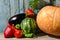 Still life of vegetables: pumpkin, watermelon, eggplant, peppers, tomatoes on the old background