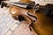 Still life with vintage violin. Closeup of old wooden violin. Stringed music instrument on abstract background