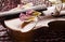 Still life with vintage violin and petals. Closeup of old wooden violin.Stringed music instrument on abstract background