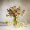 Still life with white daisies and cornflowers. Bouquet meadow flowers in the vase on the wooden table. Elegant romantic image