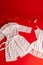 Still life: women`s white openwork chemise and negligee on a red background