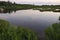 Still water of tidal pond, evening at Hammonasset Beach, Madison