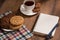 Stilllife with a notebook and cookies on the wooden table