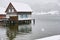 Stilt house at lake by snow flurry