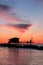 Stilt house in silhouette over the sea