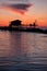 Stilt house in silhouette over the sea