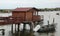 stilt houses used by fishermen and a boat on the seashore