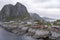 Stilt rorbuer and stockfish racks on rocks, Hamnoy Reine,  Lofoten, Norway