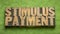 Stimulus payment word abstract in wood type