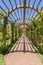 Stine brick pathway under a wooden arbor at a wedding venue on a sunny day