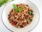 Stir fried basil with minced on a white plate,Thai food hot and spicy flavor. The ingredients are basil, garlic. Minced pork and C