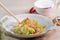 Stir-fried cabbage with sergestid Sakura shrimp in white plate on wooden table background