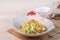 Stir-fried cabbage with sergestid Sakura shrimp in white plate on wooden table background