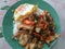 Stir Fried chicken with chilli and salt. Fried egg on top.