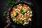 Stir fried chicken with vegetables in the pan. Top view