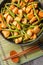 Stir fried dry red curry pad prik king with chicken and long beans closeup on the plate on the table. Vertical top view