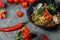 Stir-fried noodles and vegetables, in black bowl. Delicious, nutritious Asian food