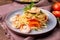 Stir-fried spaghetti or stir-fried noodles Tomato sauce and prawns on a plate and tomato basil on wooden table background, top