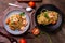 Stir-fried spaghetti or stir-fried noodles Tomato sauce and prawns on a plate and tomato basil on wooden table background, top