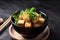 Stir fried tofu in a bowl with chopsticks. Generative AI. Vegan, vegetarian and asian food