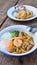 Stir fried yellow noodles with seafood , pork and soft-boiled egg , local folk south thai style