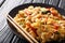 This stir-fry of wide rice noodles with chicken and fresh basil in a spicy, sweet and tangy sauce  close-up on a plate. horizontal