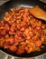 Stir-frying some migas with chorizo