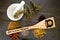Stir in some Magick - wooden stirrer with dried Herbs on gray / grey slate background