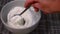 Stirring creamy thick Greek yogurt in a bowl