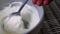 Stirring creamy thick Greek yogurt in a bowl