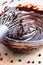 Stirring melted chocolate chips in bowl up-close on wood table