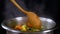 Stirring vegetable soup with a wooden spoon, slow motion