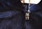 Stitching, stitch a hole in dark jeans or knit sweatpants with a sewing machine. Part of the sewing machine and denim closeup