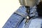 Stitching, stitching hole in blue jeans with a sewing machine. Part of sewing machine and jeans cloth closeup. Tailoring