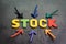Stock or equity market, investment asset concept, arrows pointing to the center with colorful letters building the word STOCK