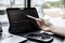 Stock investor holding a pen pointing a tablet screen that opens a stock chart program to read stock price charts.