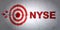 Stock market indexes concept: target and NYSE on wall background