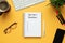 Stock photo of 2020 new year notebook with list of resolutions and objects