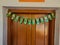 Stock photo of artificial mango leaf toran, garland or hanging door decorative item.